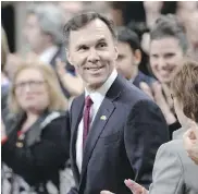  ?? ADRIAN WYLD / THE CANADIAN PRESS ?? Finance Minister Bill Morneau receives applause as he tables the federal budget.