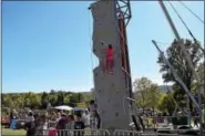  ?? PHOTOS BY MARIAN DENNIS – DIGITAL FIRST MEDIA ?? The rock climbing wall was a big hit with guests who came out to help raise awareness for childhood cancer Saturday at the Red Corner Benefit.