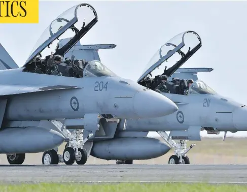  ?? PAUL CROCK / AFP / GETTY IMAGES ?? A pair of Royal Australian Air Force F-18 Hornets are seen near Melbourne. Canada is looking at the jets as a possible interim fighter option.