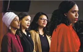  ?? Brendan Smialowski AFP/Getty Images ?? REP. AYANNA PRESSLEY, right, speaks as Reps. Ilhan Omar, left, Alexandria Ocasio-Cortez and Rashida Tlaib listen at a Capitol news conference on Monday.