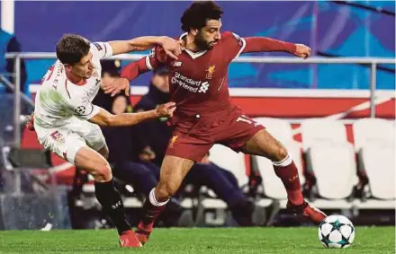  ?? REUTERS PIC ?? Liverpool’s Mohamed Salah (right) in action with Sevilla’s Clement Lenglet during their Champions League match on Tuesday.