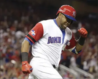  ??  ?? Dominican Republic's Nelson Cruz reacts after hitting a three-run home run during the eighth inning in a first-round game against the United States in the World Baseball Classic on Saturday in Miami. AP PHOTO