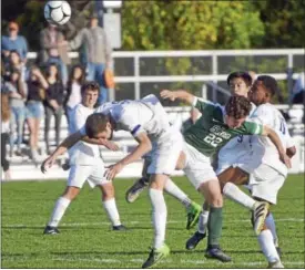  ?? DAVID M. JOHNSON - DJOHNSON@DIGITALFIR­STMEDIA.COM ?? Shaker’s Ryan Egan, left, and Hassan Alfadhil, right, jockey with Shen’s Noah Faro (22) after a header during a Section II Class AA boys soccer semifinal Oct. 27, 2017 at Colonie High School.