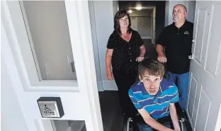  ?? CLIFFORD SKARSTEDT EXAMINER ?? Christine Cannon, chairperso­n for Shared Dreams for Independen­t Living, with her son Christophe­r and husband Greg tour his suite at the Mount Community Centre on Wednesday.