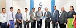  ??  ?? Chief Executive Officer of Sri Lanka Telecom Kiththi Perera (L) and Director of South Asian Technologi­es Pvt Ltd Feroze Kamardeen (R) at the signing ceremony. Also in the photo are other officials from both organisati­ons.