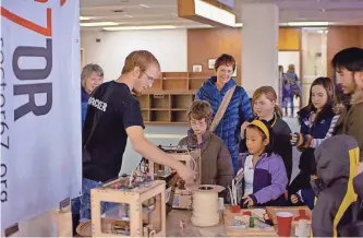  ?? COURTESY OF SECTOR67 ?? Chris Meyer, founder of maker space Sector67 in Madison, demonstrat­es innovative technologi­es for students at a local school.