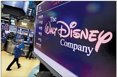  ?? AP ?? The Walt Disney Co. logo is on display this summer at the New York Stock exchange. Disney is buying a large part of the Rupert Murdoch family’s Twenty-First Century Fox Inc.