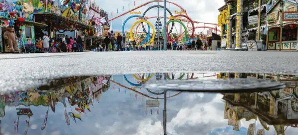  ?? Foto: Sven Hoppe, dpa ?? Das nassgraue Regenwette­r hielt fast dauerhaft an – einer der Gründe, warum es auf dem Oktoberfes­t oft vergleichs­weise ruhig war. Für die, die trotzdem kamen, brachte diese leerere Wiesn aber auch viel Gutes. Vor den Zelten bildeten sich nur selten lange Schlangen und auch ohne Tischreser­vierung gab es meist irgendwo noch ein freies Plätzchen.