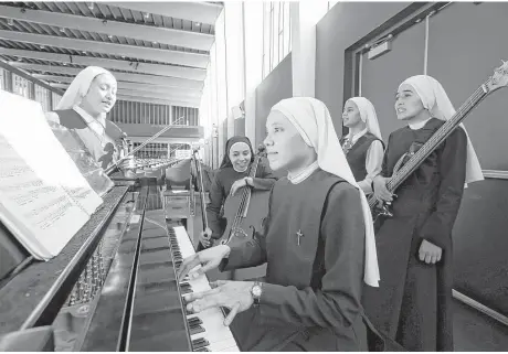  ??  ?? Members of Siervas, a Peruvian-based rock band composed of Catholic nuns, rehearse a day ahead of a Garden Grove, Calif., concert.