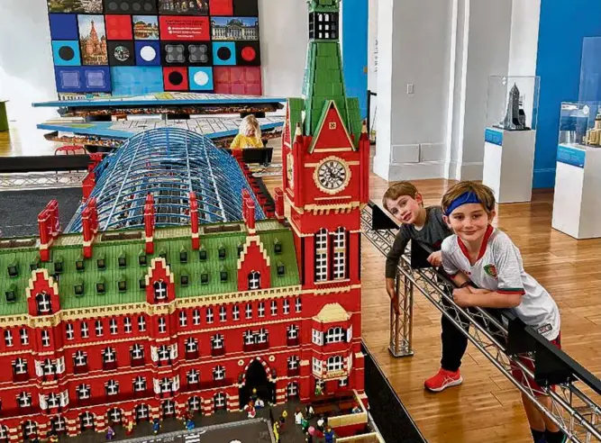  ?? PHOTOS BY PAMELA WRIGHT FOR THE BOSTON GLOBE ?? The second-floor exhibit at the National Building Museum in Washington, D.C., features a collection of iconic world landmarks and places built out of Legos, and a play area where kids could build their own Lego constructi­ons.