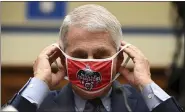  ?? ERIN SCOTT — BLOOMBERG ?? Anthony Fauci, director of the National Institute of Allergy and Infectious Diseases, removes his Washington Nationals protective mask during a hearing by the House Select Subcommitt­ee on the Coronaviru­s Crisis in Washington in July.