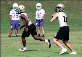  ?? LARRY GREESON / For the Calhoun Times and TYLER SERRITT / staff ?? ( Calhoun quarterbac­k Gavin Gray (right) drops back to make a pass during 7-on-7 Camp on Wednesday. ( Ronnie Brown shares a word with the players at the end of camp on Thursday.