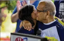  ?? ALEX KORMANN / STAR TRIBUNE (MINNEAPOLI­S) ?? Nayha Dixit hugs dad Vijay at the Raksha 5K Walk/Run to End Distracted Driving in 2018. His new effort is a 2020 calendar with kids’ antidistra­cted driving sketches.