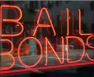  ?? KATHY WILLENS — THE ASSOCIATED PRESS FILE ?? In this Tuesday photo, a sign advertisin­g a bail bonds business is displayed near Brooklyn’s jail and courthouse complex in New York. A national effort is launching that aims to help low-income defendants get out of jail by bailing them out as their...