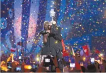  ?? AP-Yonhap ?? Salvador Sobral from Portugal, right, embraces his sister Luisa after performing the song “Amar pelos dois” following his win in the final of the Eurovision Song Contest in Kiev, Ukraine, Saturday.