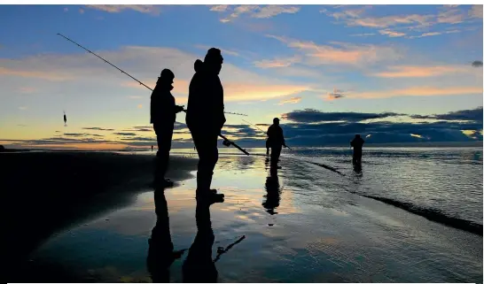  ?? PHOTO: PETER MEECHAM/FAIRFAX NZ ?? Salmon fisherman at the mouth of the Waimakarir­i River at first light.