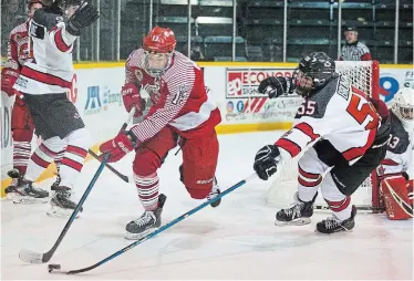  ?? BOB TYMCZYSZYN TORSTAR ?? St. Catharines’ Michael Santini, left, is defended by Niagara Falls’ Andrew Bruno (55) at Jack Gatecliff Arena in St. Catharines in junior B hockey action Friday night.