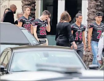  ?? SUN-SENTINEL] [MIKE STOCKER/ SOUTH FLORIDA ?? Football players wore their jerseys in tribute to Marjory Stoneman Douglas High School assistant coach Aaron Feis during his funeral in Coral Springs, Fla.