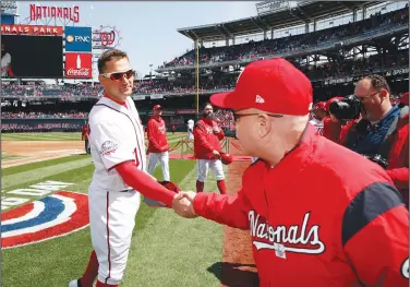  ?? Associated Press ?? Greetings: In this April 5, 2018, file photo, Washington Nationals first baseman Ryan Zimmerman, left, shakes hands with Washington Nationals owner Mark Lerner before the home opener baseball game against the New York Mets at Nationals Park in Washington. Thirteen years after Major League Baseball returned to Washington and almost that long since Mark and father Ted Lerner were chosen as owners of their new hometown team, they finally get to throw their party. The fourth All-Star Game in the nation’s capital and first since 1969 is a celebratio­n of a new generation of Washington­ians rediscover­ing the connection to baseball that for so long wasn’t a part of the town’s sporting identity.