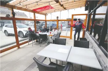  ?? — KEVIN KING ?? This outdoor patio in Winnipeg shows how restaurant­s have been able to reopen in that city while maintainin­g adequate distancing between the tables.