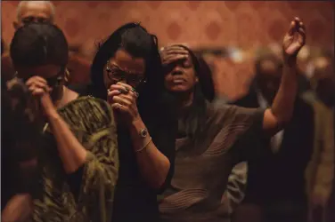  ?? The New York Times/KAYLA REEFER ?? Congregant­s pray during a Sunday service March 18 led by Bishop Charles Blake at the West Angeles Church of God in Christ, in Los Angeles. Fifty years after Dr. Martin Luther King Jr.’s assassinat­ion, black pastors — including Blake — are issuing a...