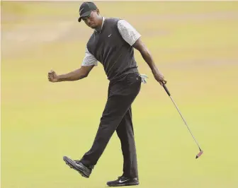  ?? AP PHOTOS ?? IN THE MIX: Tiger Woods, who is 4 shots off the lead, celebrates a birdie at the ninth hole during yesterday’s third round of the British Open in Carnoustie, Scotland. Above, co-leader Jordan Spieth gives the crowd a thumb up after his 6-under 65.