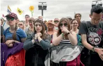  ?? GETTY IMAGES ?? People at the Glastonbur­y Festival observe a minute’s silence for the victims of recent terror attacks and the Grenfell Tower fire.