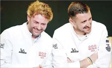  ?? AFP ?? French chef Arnaud Donckele (left) and French chef Dimitri Droisneau celebrate after being awarded a third Michelin star during the 2022 edition of the Michelin guide award ceremony at the Avant Scene theatre in Cognac in western France on Tuesday.