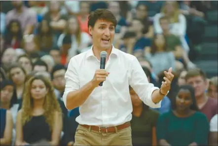  ?? GARY NYLANDER/The Daily Courier ?? Prime Minister Justin Trudeau speaks during a town hall meeting Wednesday night at the UBC Okanagan gymnasium.