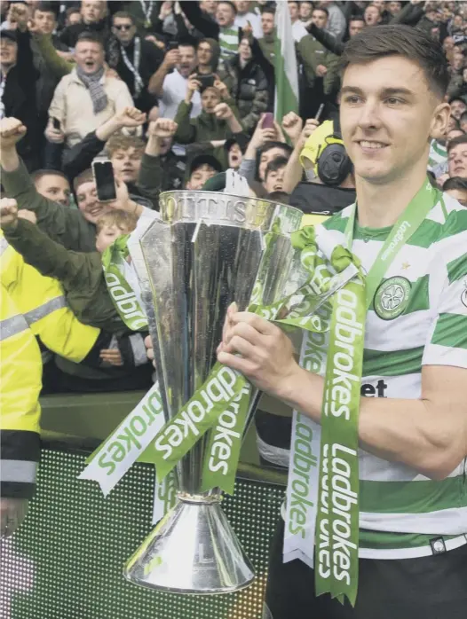  ??  ?? 0 Kieran Tierney was kept out of Celtic’s 2-0 win over Hearts on Sunday but joined in the after-match celebratio­ns on the pitch and in the stands after the Parkhead squad lifted the Ladbrokes Premiershi­p trophy.