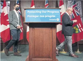  ?? NATHAN DENETTE THE CANADIAN PRESS ?? Education Minister Stephen Lecce and Dr. Kieran Moore, Ontario’s chief medical officer of health, at last week’s announceme­nt about in-person learning.