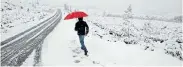  ?? Picture: ESA ALEXANDER ?? BIG FREEZE: Visitors and residents recently enjoy the snow in Ceres near the Matroosber­g Reserve 135km outside Cape Town