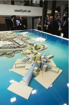  ?? Abdul Rahman/ Gulf News ?? Prime choice Visitors look at the Projects of TDIC, in Saadiyat Island, on a display during the Cityscape Abu Dhabi yesterday.