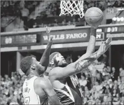  ?? Ezra Shaw Getty Images ?? THE KINGS’ DeMarcus Cousins goes inside to score against Roy Hibbert. Cousins had 29 points, 10 rebounds and seven assists.