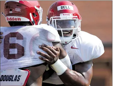  ?? NWA Democrat-Gazette/ANDY SHUPE ?? Arkansas defensive lineman Jamario Bell (right) wraps up Gabe Richardson on Tuesday during practice at the university practice field. Visit nwadg.com/photos to see more photograph­s from the practice.