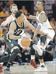  ?? AP PHOTO ?? Toronto Raptors guard DeMar DeRozan, centre, drives past Cleveland Cavaliers J.R. Smith, right, during Wednesday’s game in Cleveland.