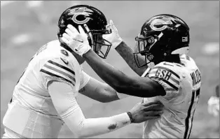  ?? TODD KIRKLAND/GETTY ?? QB Nick Foles and WR Anthony Miller celebrate after connecting for the game-winning TD on Sunday.