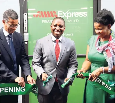  ?? CONTRIBUTE­D ?? Elson James, CEO of the new microfinan­cing outfit JMMB Express Finance, is flanked by JMMB Group Chairman Archibald Campbell (left) and JMMB human resource consultant Diana Burgess who assist him in cutting the ribbon, during the launch of JMMB Express on September 12, at 86 Ramsaran Street, Chaguanas, Trinidad and Tobago. The new subsidiary will provide unsecured consumer financing.