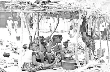  ?? — Reuters photo ?? People sit at the Abagena IDPs camp in Benue, Nigeria.