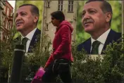  ?? EMRAH GUREL — THE ASSOCIATED PRESS ?? A person walks past billboards of Turkish President and People's Alliance's presidenti­al candidate Recep Tayyip Erdogan a day after the presidenti­al election day, in Istanbul, Turkey, on Monday.