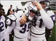  ?? LM Otero / Associated Press ?? TCU kicker Griffin Kell (39) celebrates with Jordy Sandy (31) and other teammates after hitting a field goal in the final seconds of a win over Bayor on Saturday.