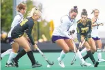  ?? JOSEPH CRESS / ASSOCIATED PRESS ?? Northweste­rn’s Lauren Wadas, middle, battles for a ball with Iowa’s Lokke Stribos, left, and Ciara Smith during a 2021 field hockey game in Iowa City, Iowa.