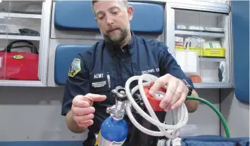  ?? LISA RATHKE/AP ?? Scott Brinkman, chief of Stowe Department of Emergency Medical Services, demonstrat­es how nitrous oxide is used in an ambulance, in Stowe, Vt. Several rural ambulance crews are using nitrous oxide, or laughing gas, to treat patients’ pain en route to the hospital when paramedics aren’t on board to provide narcotics.