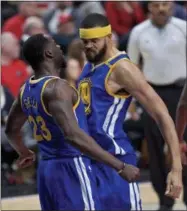  ?? CRAIG MITCHELLDY­ER — THE ASSOCIATED PRESS ?? Golden State Warriors forward Draymond Green, left, and Golden State Warriors center JaVale McGee react after a McGee dunk against the Portland Trail Blazers during the first half of Game 4 of an NBA basketball first-round playoff series Monday in...