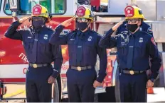  ?? MARK RIGHTMIRE/THE ORANGE COUNTY REGISTER ?? Anaheim firefighte­rs salute the procession carrying fallen firefighte­r Charles Morton, killed while battling a blaze in the mountains east of Los Angeles, in Orange, Calif., Tuesday.