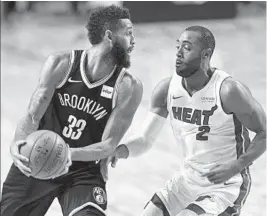  ?? PEDRO PARDO/GETTY IMAGES ?? Brooklyn’s Allen Crabbe vies for the ball with Miami’s Wayne Ellington during Saturday’s game in Mexico City. Both teams had to deal with altitude issues.