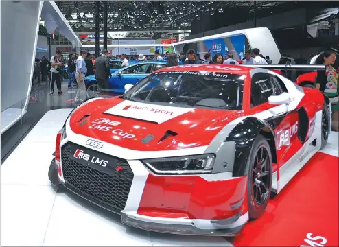  ?? LU ZHE / XINHUA ?? An Audi R8 LMS serves up an auto feast for enthusiast­s at the Beijing auto show last year.