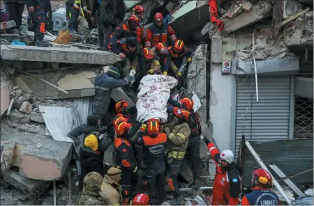  ?? AP PHOTO/CAN OZER ?? Turkish rescue workers carry Ergin Guzeloglan, 36, to an ambulance after they pulled him out of a collapsed building five days after an earthquake in Hatay, southern Turkey. Emergency crews made a series of dramatic rescues in Turkey on Friday, pulling several people, some almost unscathed, from the rubble, four days after a catastroph­ic earthquake.