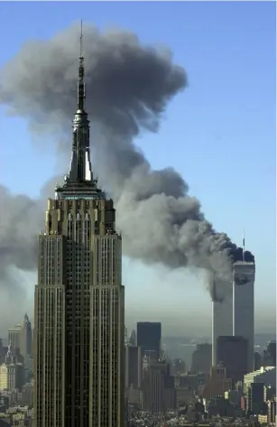  ?? Patrick Sison/Associated Press ?? Smoke rise from the World Trade Center buildings in New York City, after the 9/11 terrorist attacks.