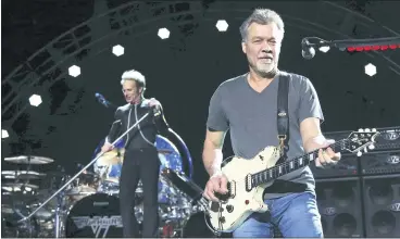  ?? GREG ALLEN — INVISION/AP, FILE ?? David Lee Roth, left, and Eddie Van Halen of Van Halen perform in 2015inWant­agh, N.Y. Van Halen, who had battled cancer, died Tuesday. He was 65.